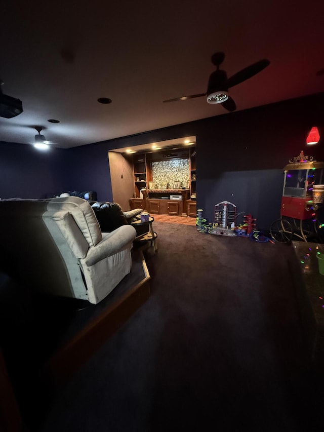 cinema with ceiling fan and carpet flooring