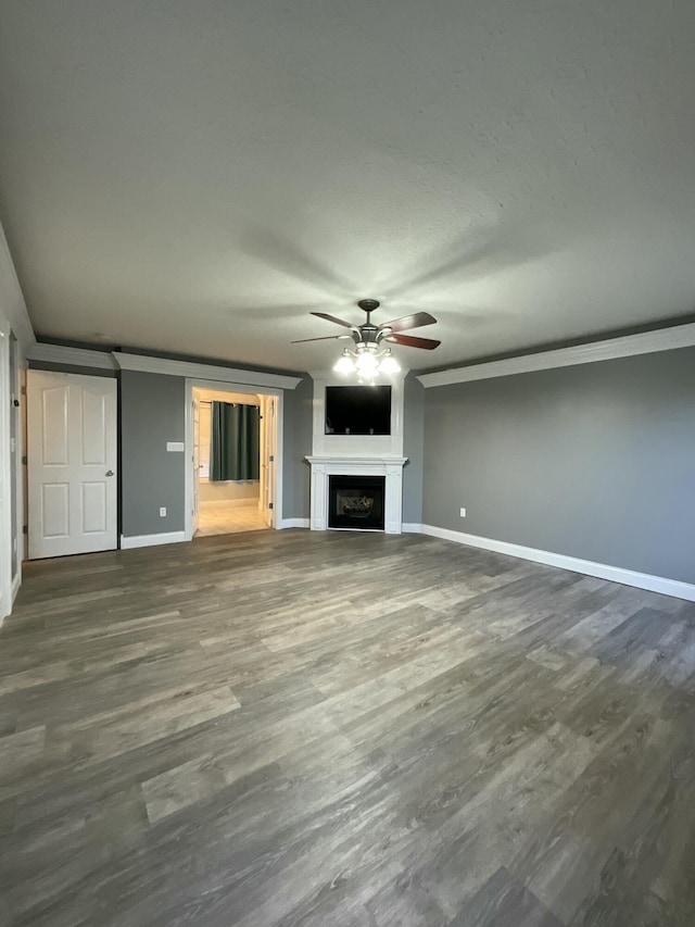 unfurnished living room with dark wood-type flooring and ceiling fan