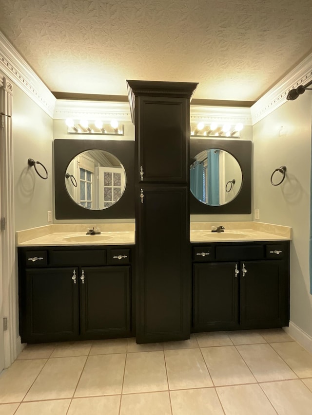 bathroom featuring vanity, crown molding, and a textured ceiling