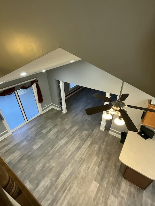 additional living space featuring vaulted ceiling and dark wood-type flooring