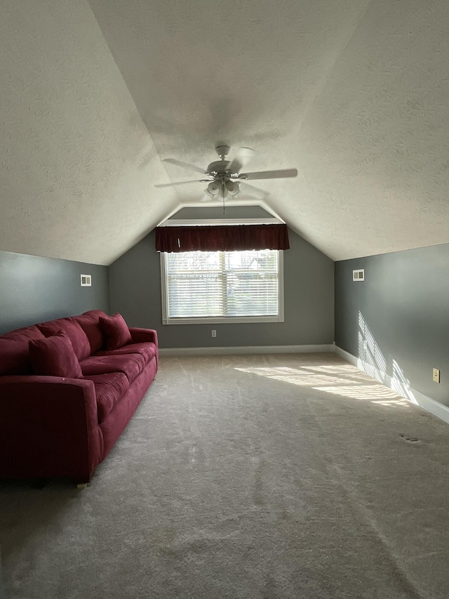 bonus room with ceiling fan, lofted ceiling, carpet floors, and a textured ceiling