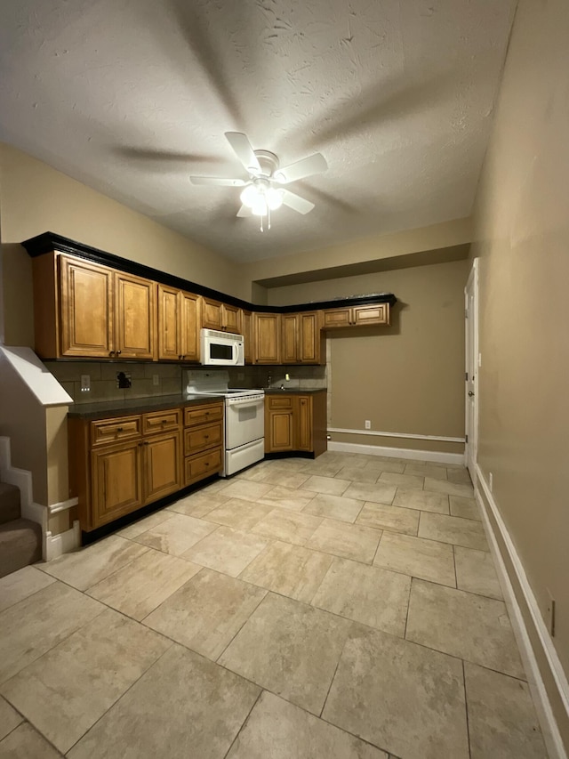 kitchen with ceiling fan, backsplash, a textured ceiling, and white appliances