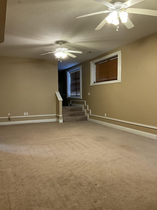 carpeted spare room with ceiling fan