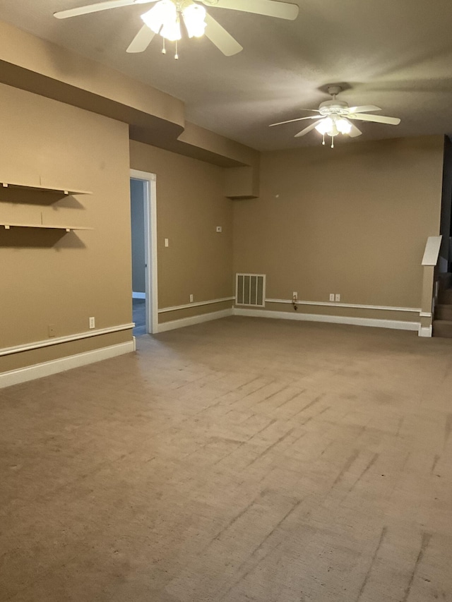 unfurnished living room with carpet and ceiling fan