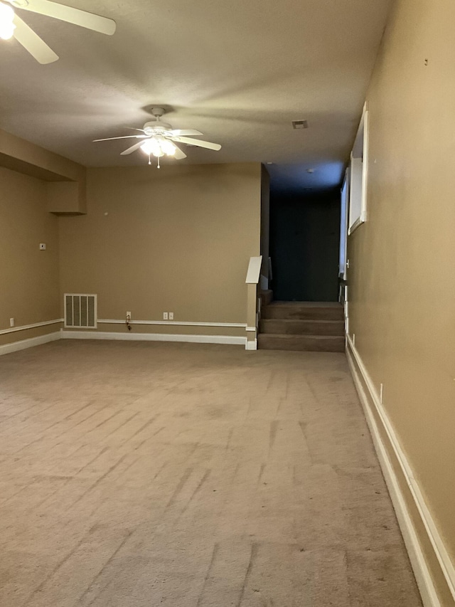 carpeted spare room featuring ceiling fan