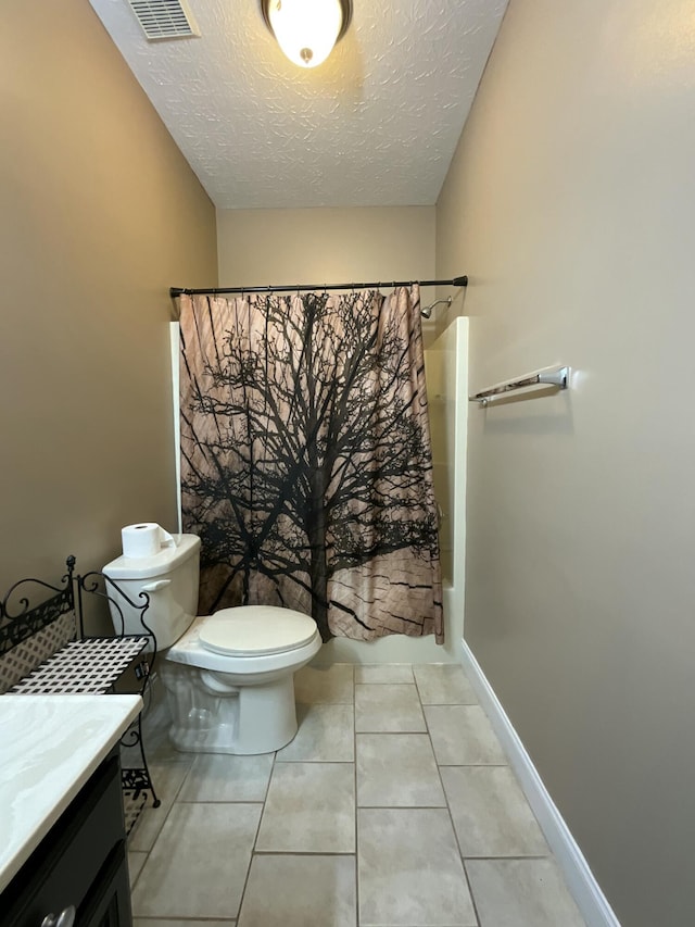 full bathroom featuring vanity, shower / bath combination with curtain, a textured ceiling, tile patterned floors, and toilet