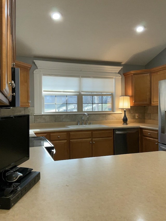 kitchen featuring electric stove, sink, decorative backsplash, and black dishwasher