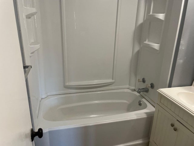 bathroom with vanity and shower / washtub combination