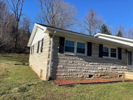 view of side of home featuring a lawn