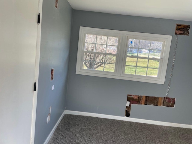 carpeted spare room with a healthy amount of sunlight