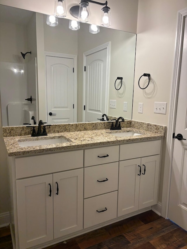 bathroom with vanity, wood-type flooring, and walk in shower