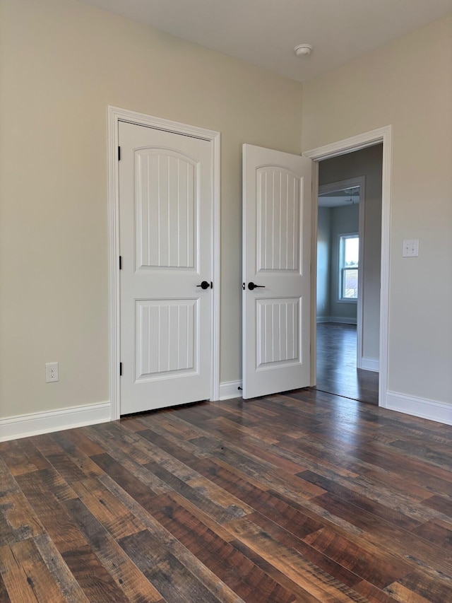 unfurnished bedroom with dark hardwood / wood-style floors