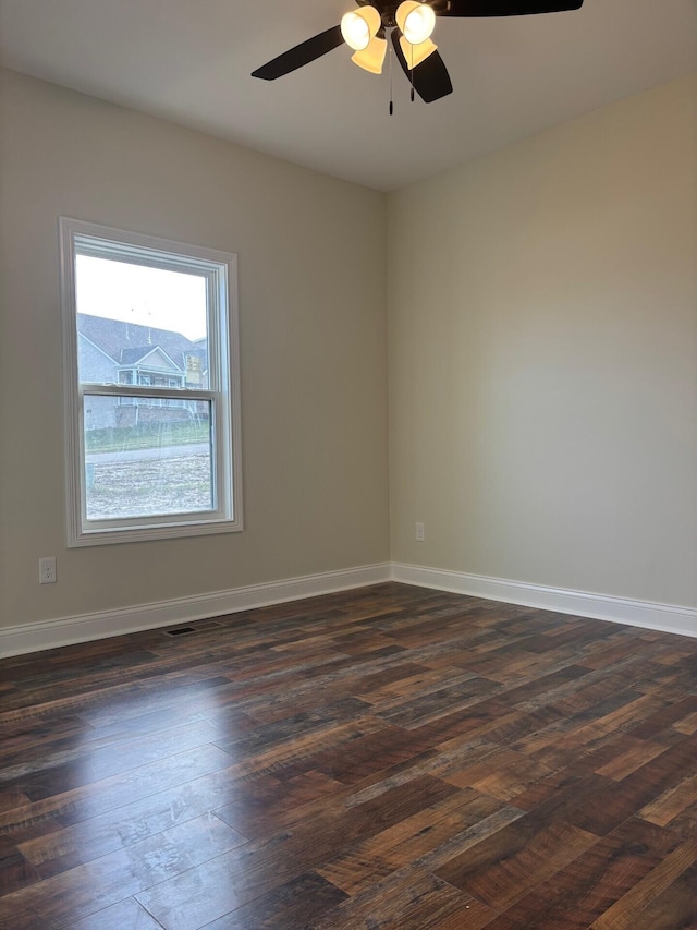 unfurnished room featuring ceiling fan and dark wood-type flooring