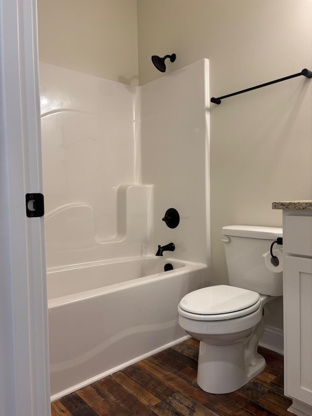 full bathroom with hardwood / wood-style flooring, vanity, toilet, and shower / tub combination