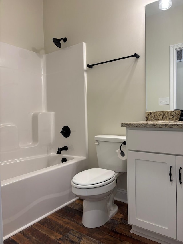 full bathroom featuring wood-type flooring, vanity, toilet, and shower / washtub combination