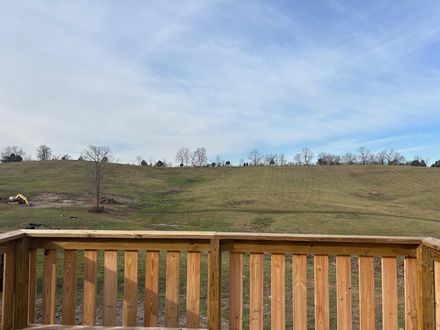 wooden terrace featuring a rural view