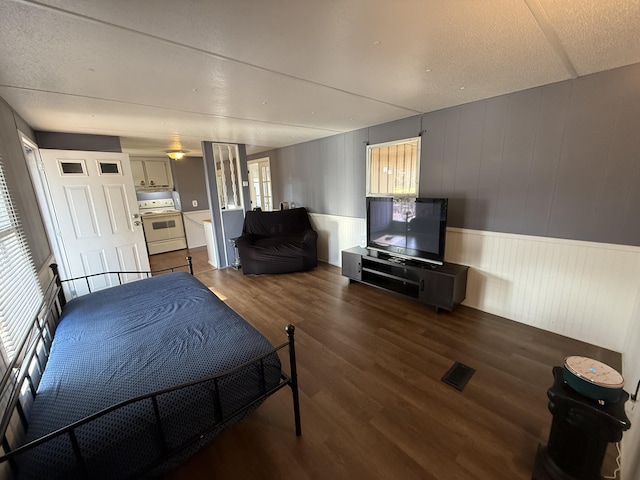 bedroom with dark hardwood / wood-style floors