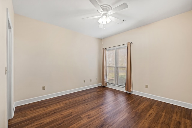 empty room with ceiling fan and dark hardwood / wood-style flooring