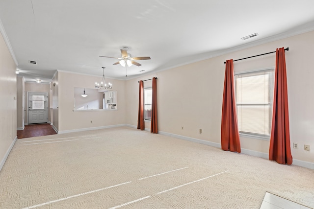 carpeted empty room featuring ceiling fan with notable chandelier and ornamental molding