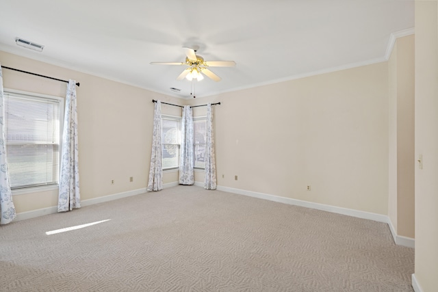 carpeted empty room featuring ceiling fan and crown molding