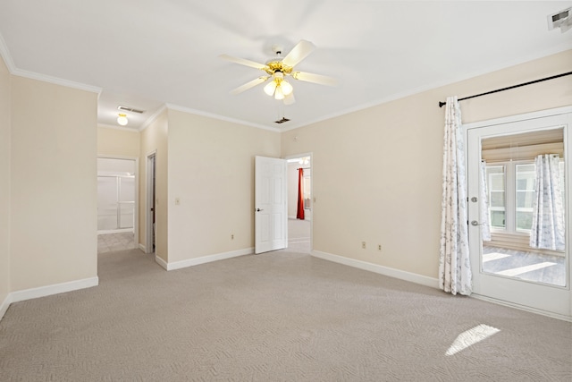 spare room featuring light carpet, ceiling fan, and ornamental molding