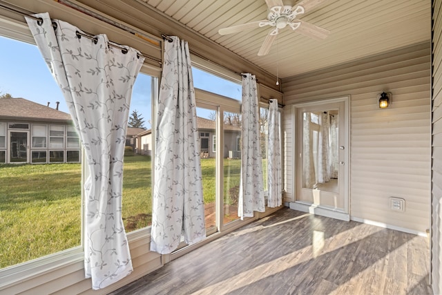 unfurnished sunroom with ceiling fan