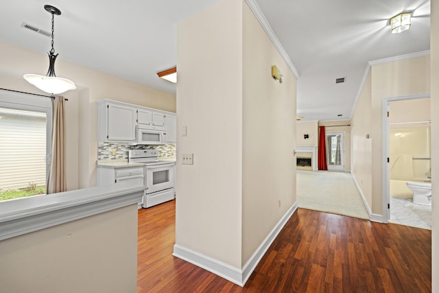 hallway with wood-type flooring and ornamental molding