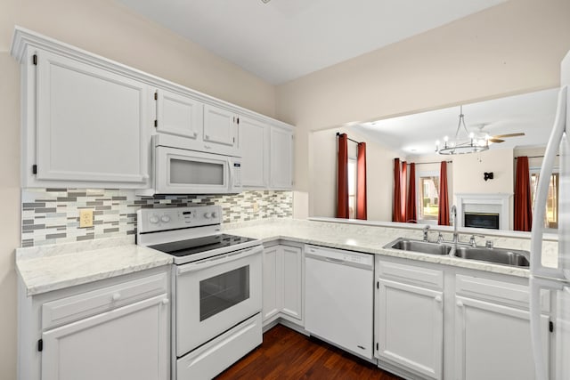 kitchen featuring white cabinetry, sink, dark hardwood / wood-style flooring, white appliances, and decorative backsplash