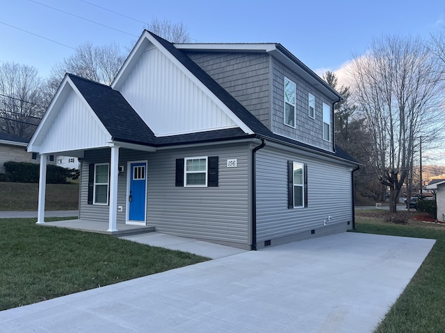 view of front of property with a lawn and a porch