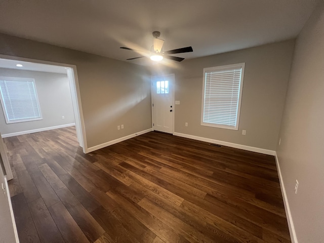 unfurnished room with ceiling fan and dark hardwood / wood-style flooring