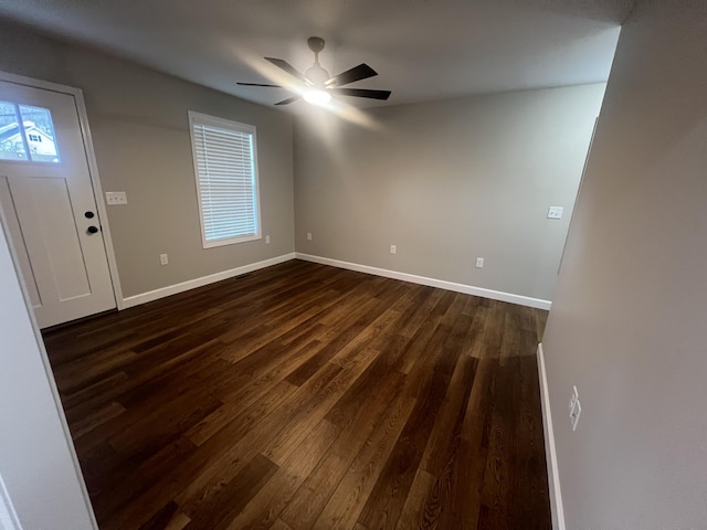 empty room featuring ceiling fan and dark wood-type flooring