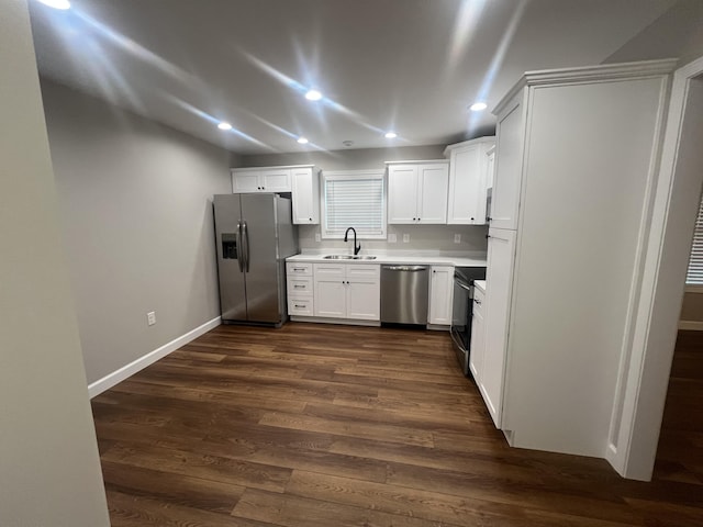 kitchen with stainless steel appliances, white cabinetry, dark hardwood / wood-style floors, and sink