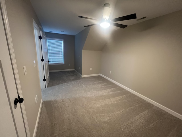 additional living space featuring ceiling fan, carpet, and vaulted ceiling