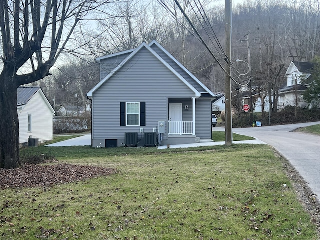 bungalow-style house featuring cooling unit and a front lawn