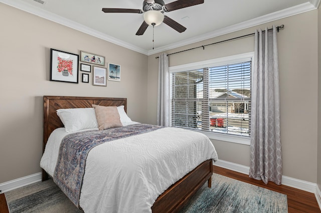 bedroom featuring dark hardwood / wood-style flooring, ceiling fan, and ornamental molding