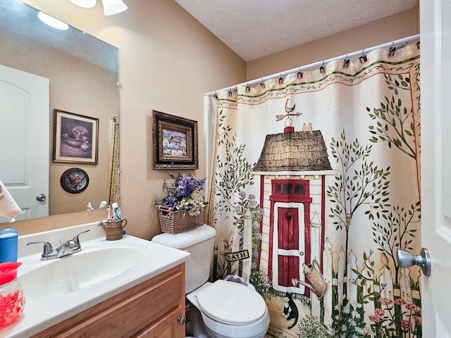 bathroom with vanity, a textured ceiling, and toilet