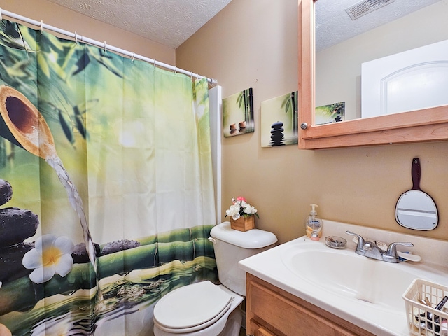 bathroom featuring vanity, toilet, and a textured ceiling