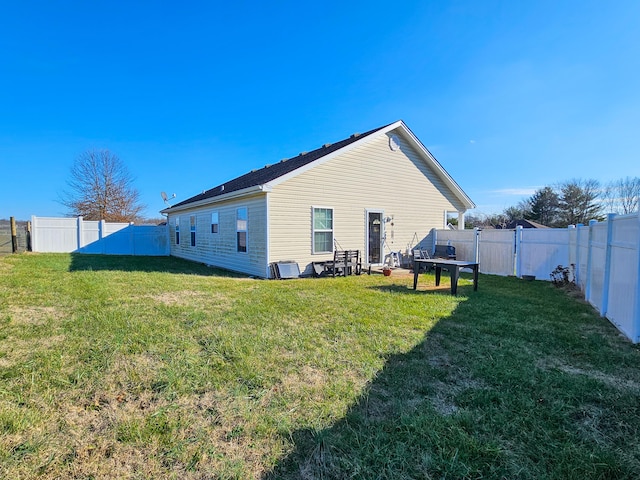 rear view of property featuring a lawn