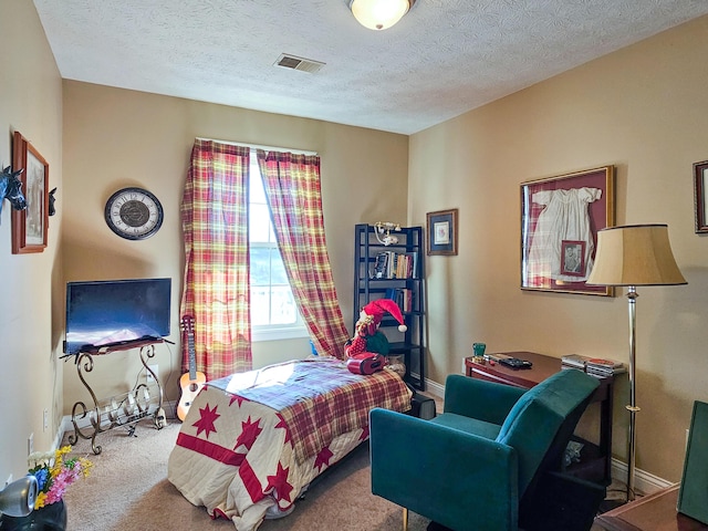 bedroom featuring carpet flooring and a textured ceiling