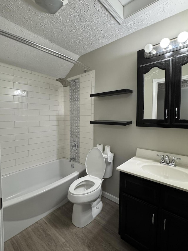 full bathroom featuring vanity, a textured ceiling, hardwood / wood-style flooring, toilet, and tiled shower / bath