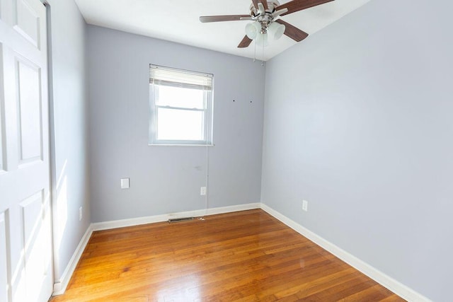 spare room featuring wood-type flooring and ceiling fan