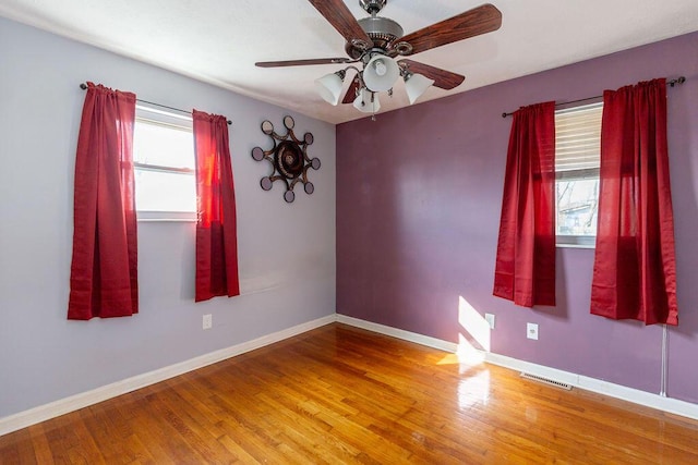 unfurnished room with ceiling fan and wood-type flooring