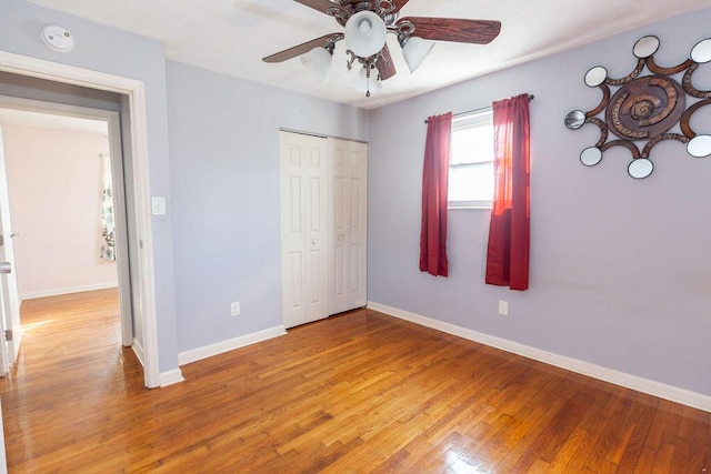 unfurnished bedroom featuring a closet, ceiling fan, and hardwood / wood-style flooring