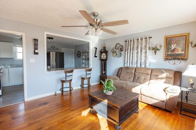 living room featuring ceiling fan and hardwood / wood-style floors