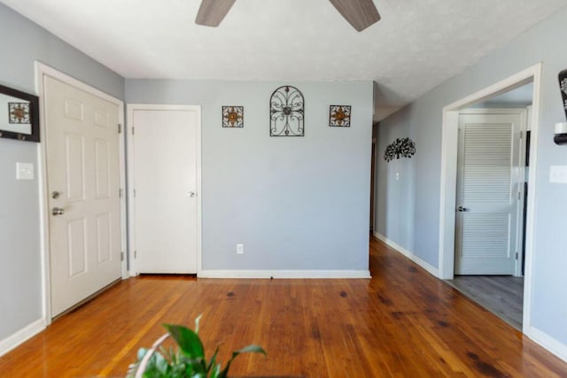 interior space with wood-type flooring and ceiling fan