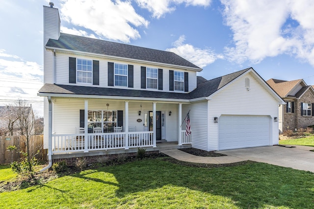 view of front of house featuring a porch, a front yard, and a garage