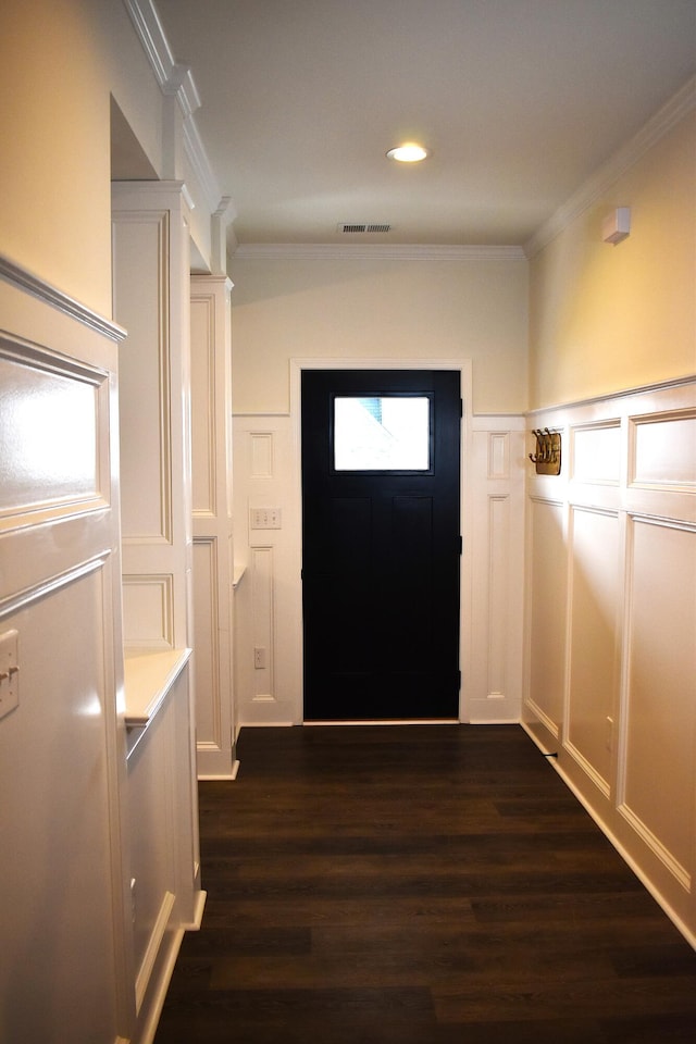 doorway with dark hardwood / wood-style floors and ornamental molding