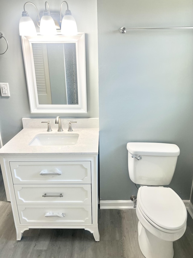 bathroom featuring vanity, toilet, and wood-type flooring