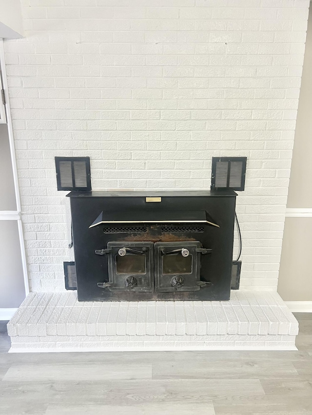 room details featuring wood-type flooring and a wood stove