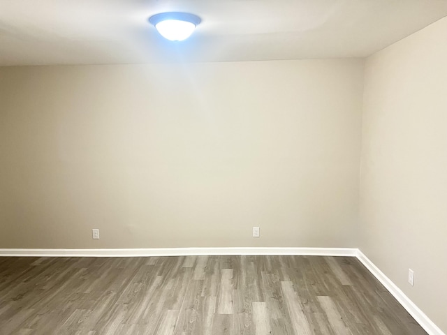 unfurnished room with hardwood / wood-style flooring